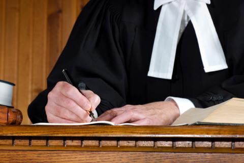 Lawyer writing with a pen