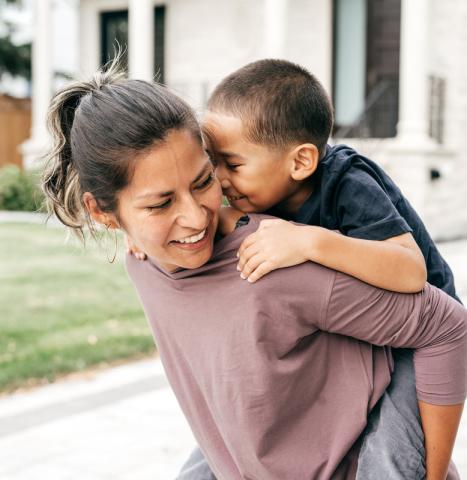 Woman carrying a child.